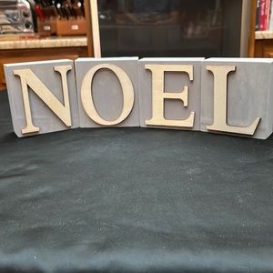 Four Decorative Light Weight Balsam Wood Blocks that spell NOEL.  4 3/4 Tall.